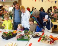 Children and parents fascinated by the miniature gardens made by children