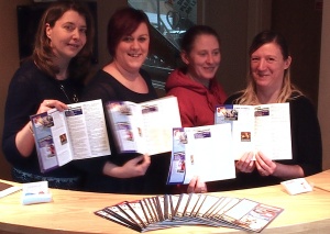The team which has brought a new community magazine to Menston. Left to Right: Louise Atkinson, partner and graphic designer, Cathy Frobisher , Office Manager, Janet-Alison Arkwright , Partner and 'Sales Contributor', and Andrea Kerman, Sales Person, at the reception in their offices in Haworth, each holding the first edition of the new magazine.
